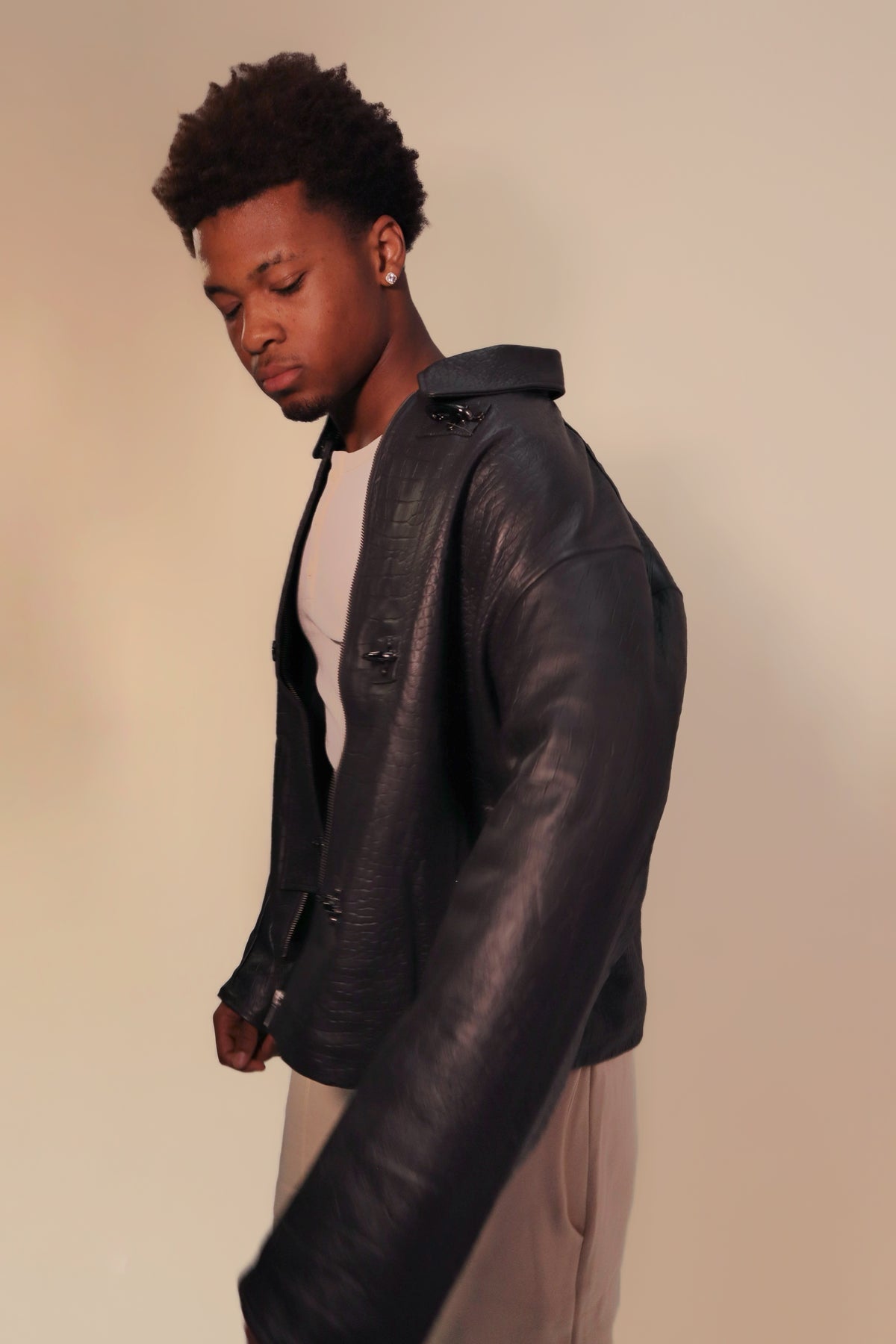 Dark gray oversized leather jacket worn on model